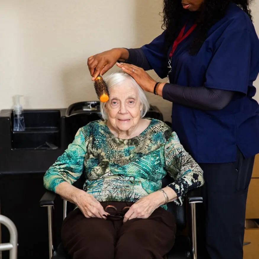 elderly woman having her hair fixed