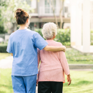 caregiver walking away with elderly woman
