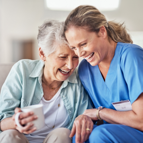 elderly lady laughing with caregiver