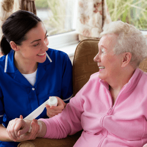 Nurse wrapping older ladies arm