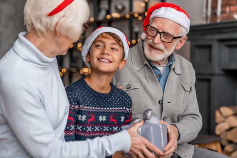 elderly grandparents with grandson on christmas