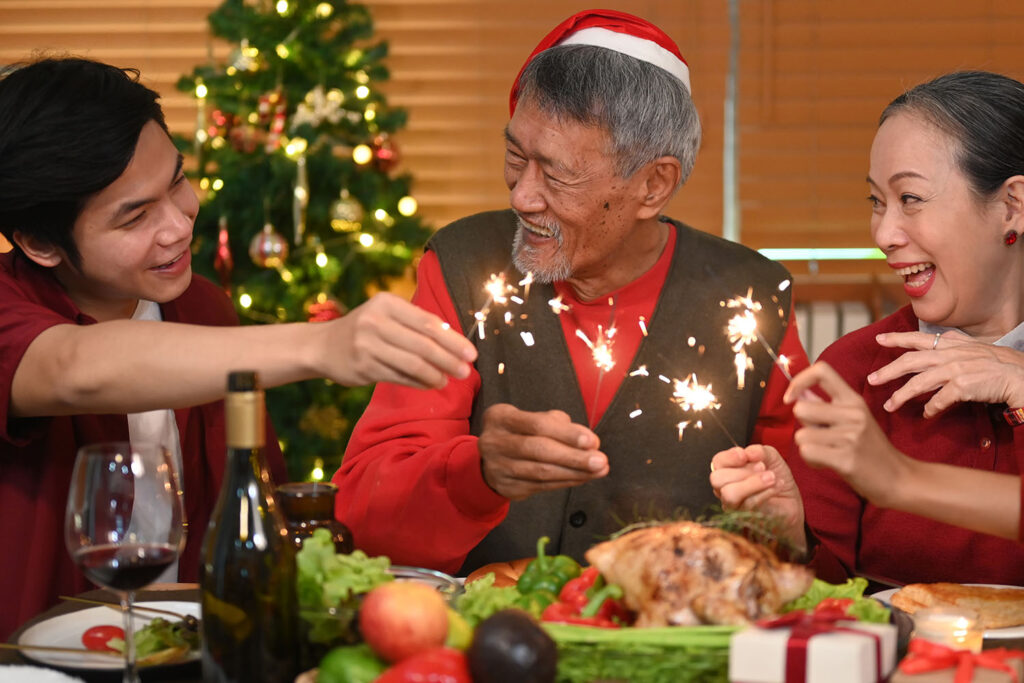 elderly holiday lighting sparklers