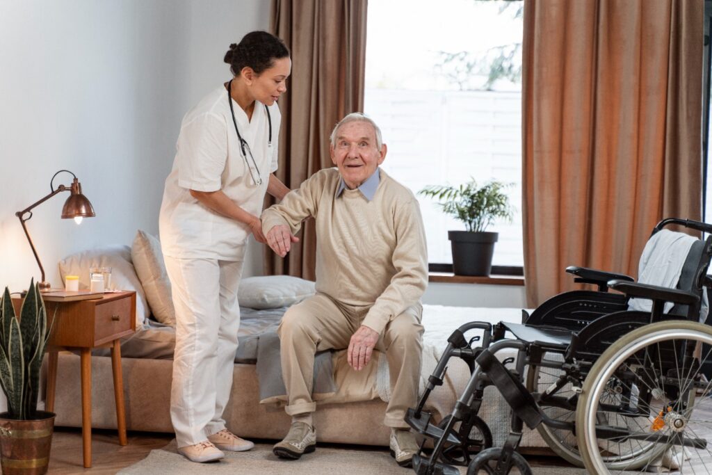 Eldery and caregiver holding hands