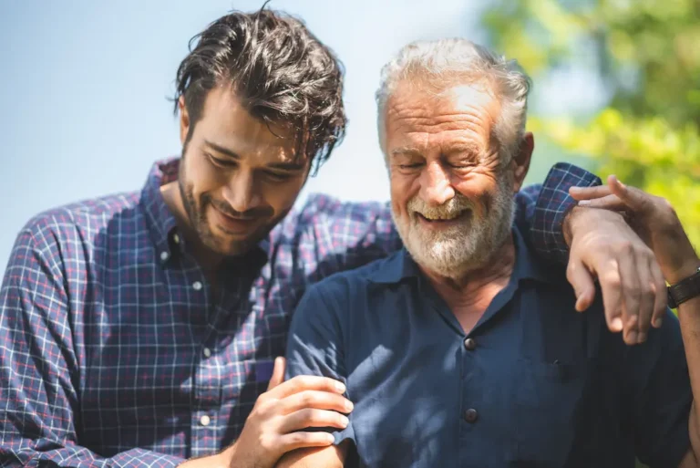 caucasian senior father and adult son are hugging together at home, generation family are happy with people love, male mature, old person man, elderly grandfather smiling living at the house