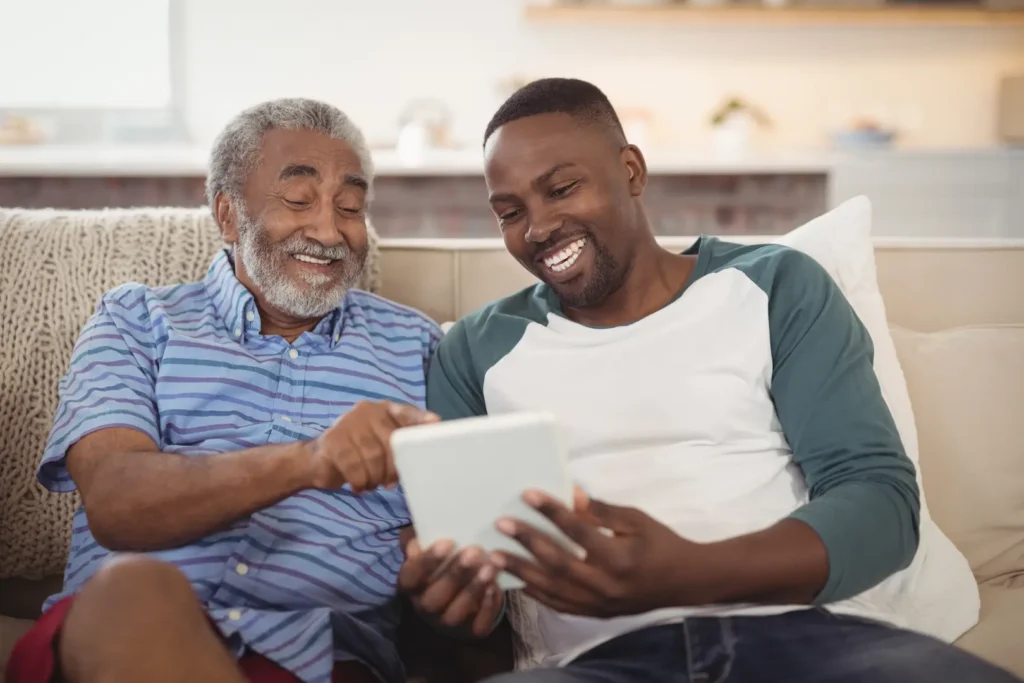 smiling father and son using digital tablet