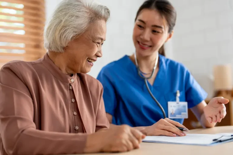 caregiver and woman looking at papers