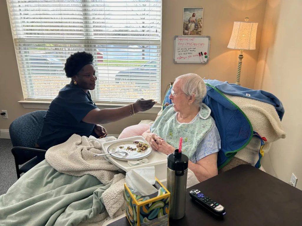 Caregiver feeds resident